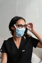 Woman wearing a SLEEVZ mask attached to her glasses