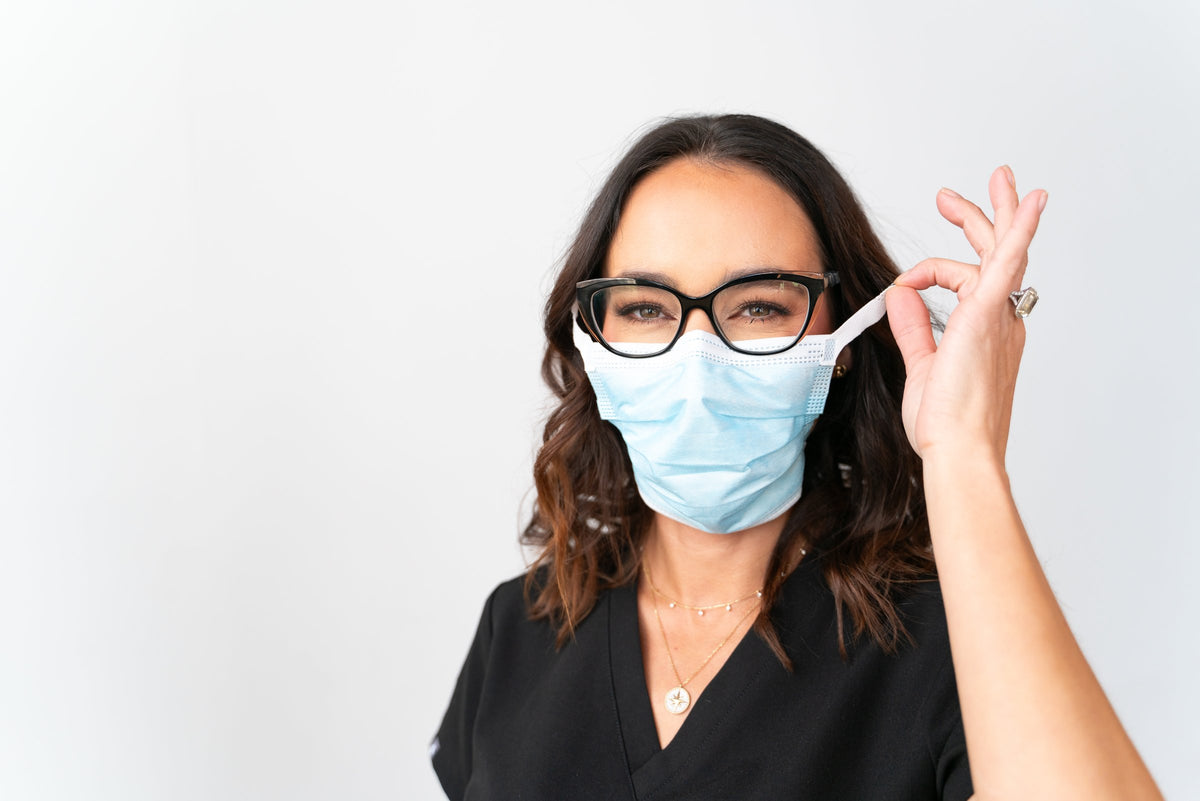 Woman wearing a SLEEVZ mask connected to her eyewear