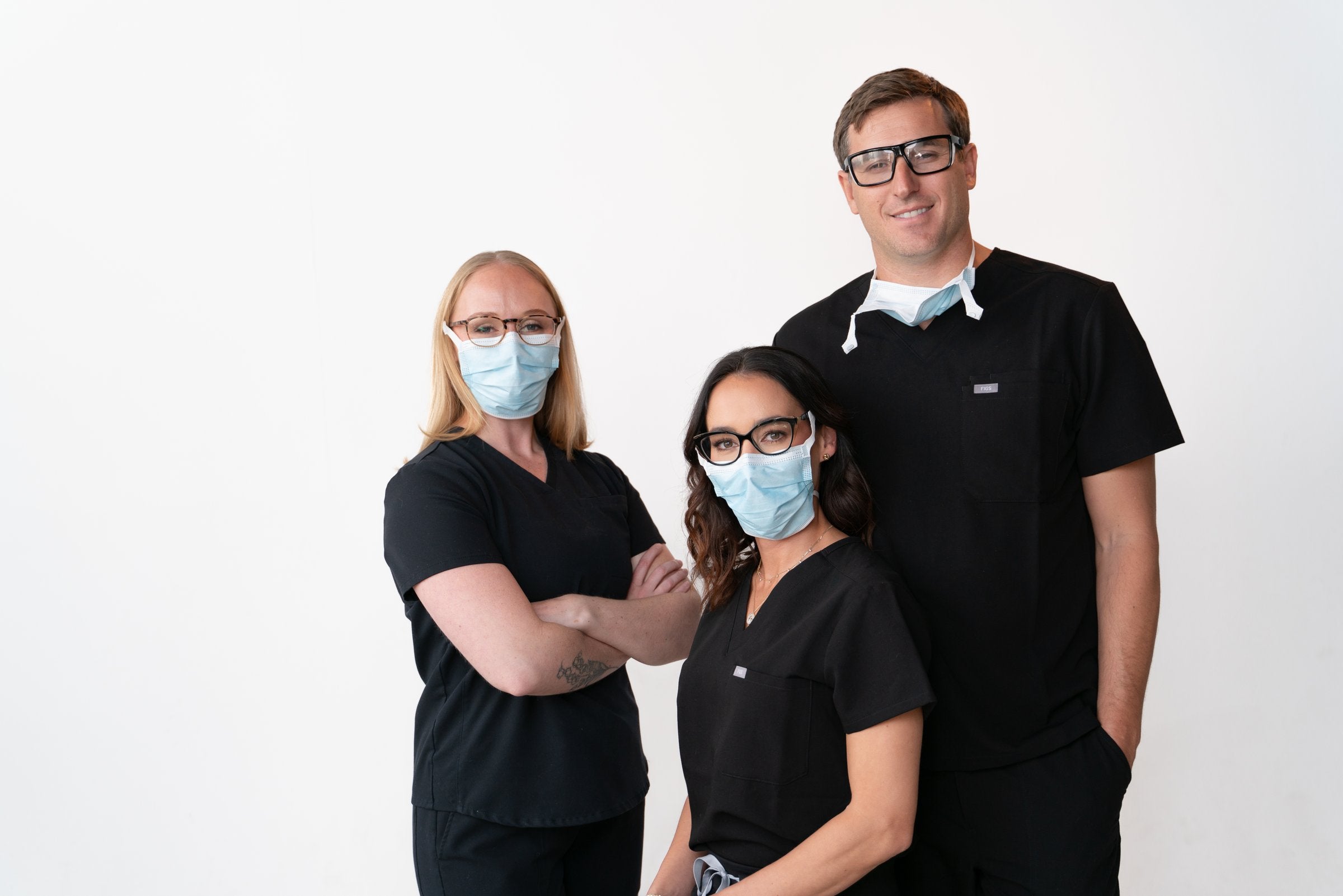 Three people wearing SLEEVZ masks with their glasses