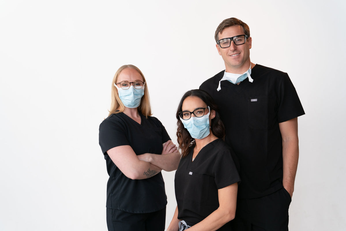 Three people wearing SLEEVZ masks with their glasses