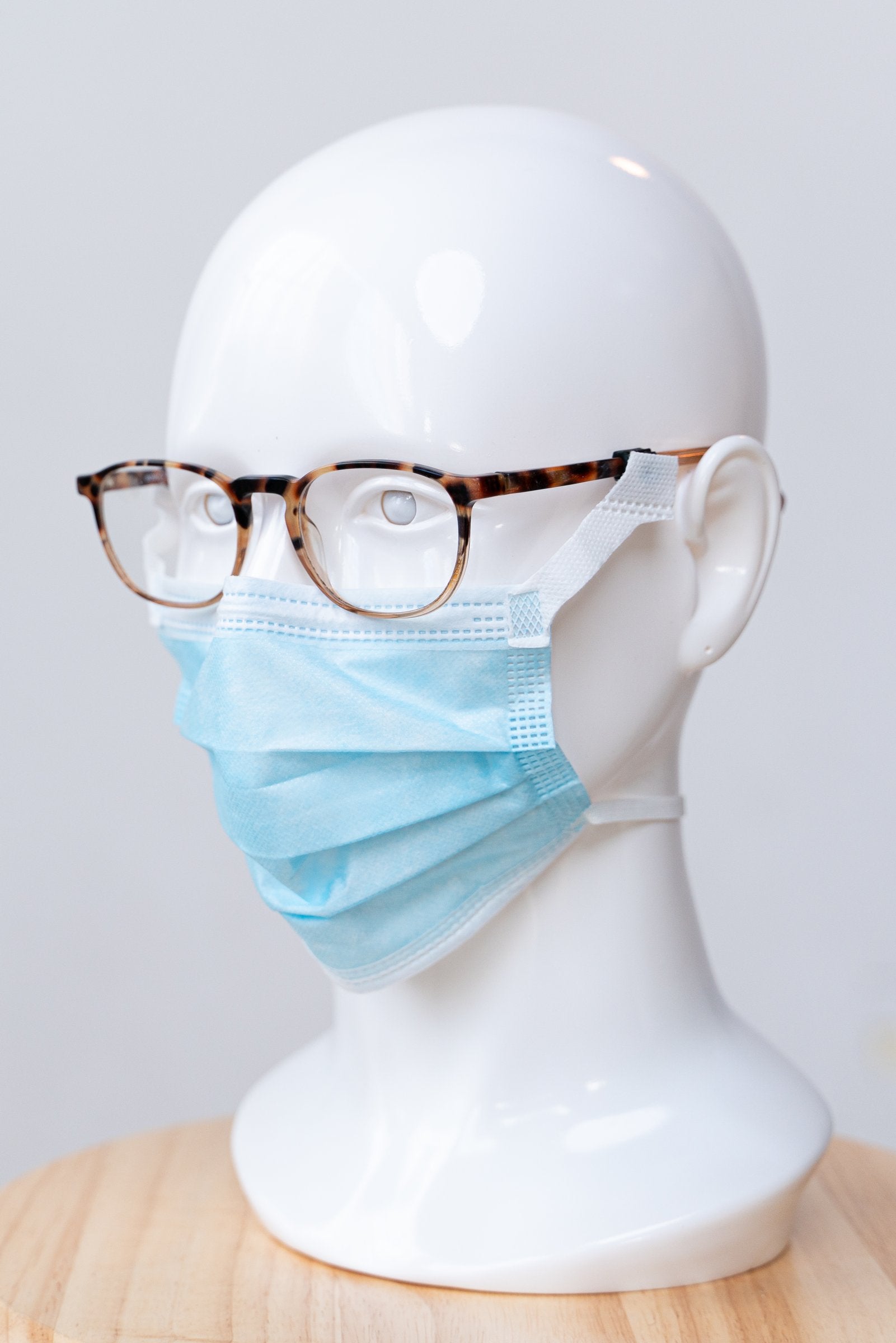 SLEEVZ disposable mask attached to eyeglasses on a display head
