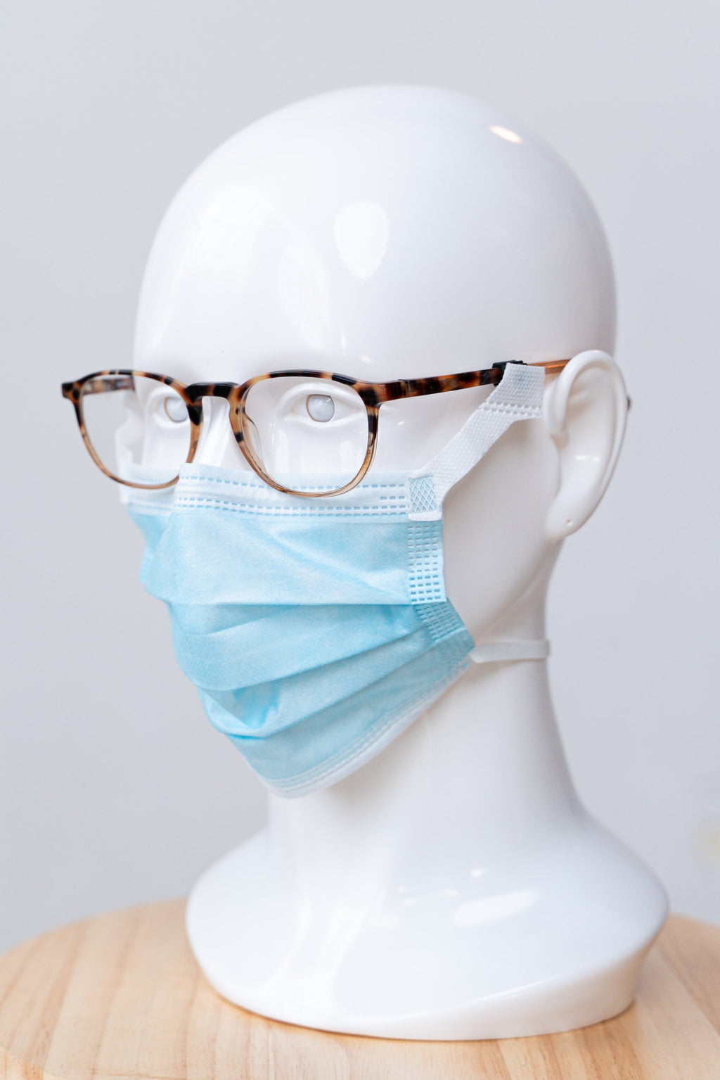 SLEEVZ disposable mask attached to eyeglasses on a display head